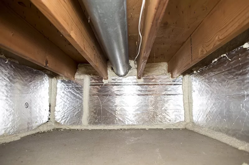 Inside a crawl space with insulation