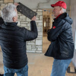 Two Rockweiler team members in a room at a job site.