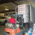 Forklift driver loading a company truck.