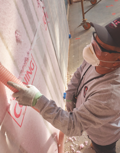 Construction worker wearing a mask and safety glasses