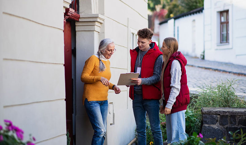 Homeowner greeting a door-to-door saleperson