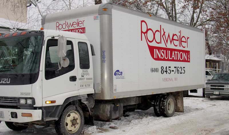 Rockweiler Insulation service truck parked on a snowy residential street in Wisconsin.