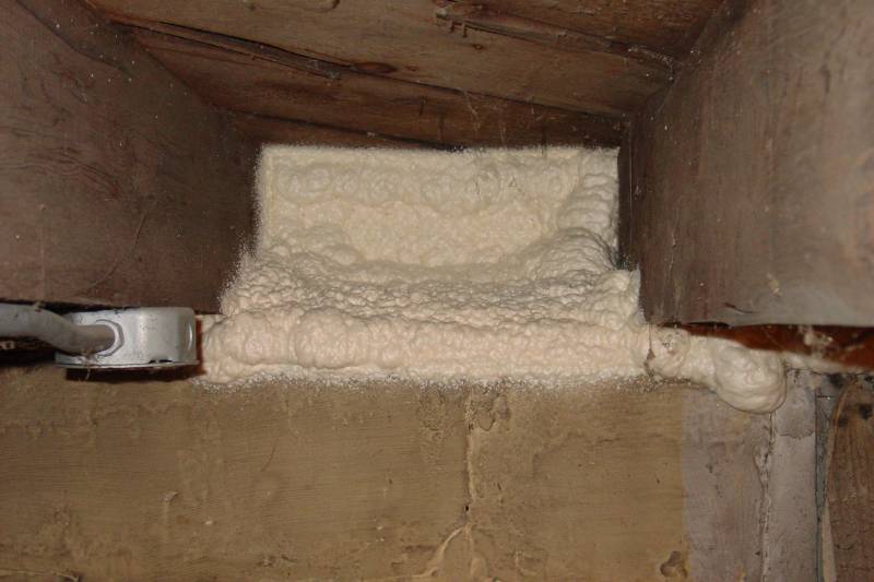 Completed spray foam seal in a basement rim joist bay.