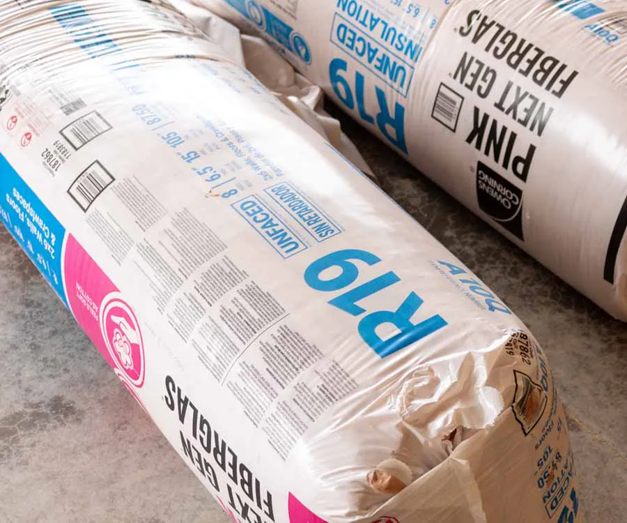 Rolls of Owens Corning PINK Next Gen Fiberglas R-19 unfaced insulation staged on a Rockweiler Insulation job site in Madison, WI.